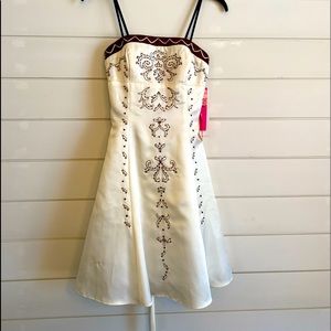 Ivory dress with brown accents/rhinestones. Back is a corset style tie. Size 3/4